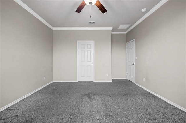 empty room featuring crown molding, ceiling fan, dark colored carpet, and baseboards