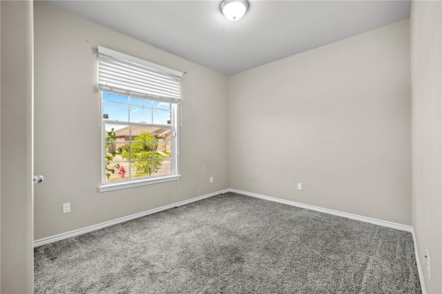 empty room with carpet floors and baseboards