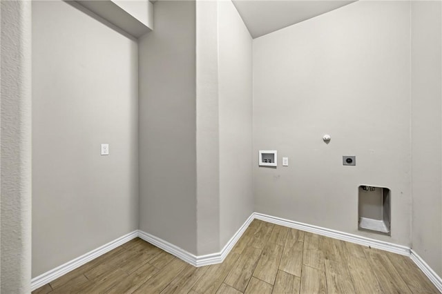 laundry area featuring laundry area, electric dryer hookup, light wood-type flooring, washer hookup, and baseboards