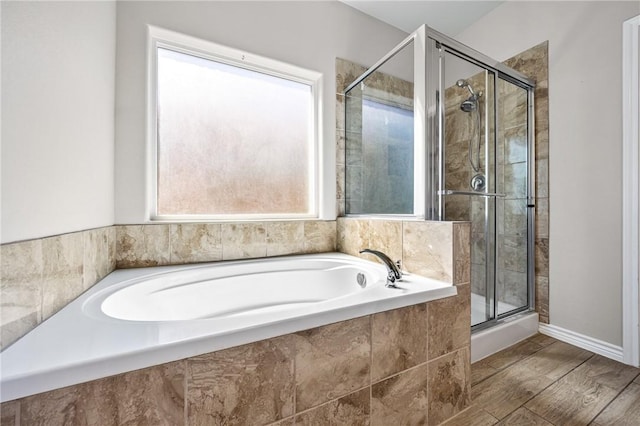 full bath featuring a stall shower and a garden tub