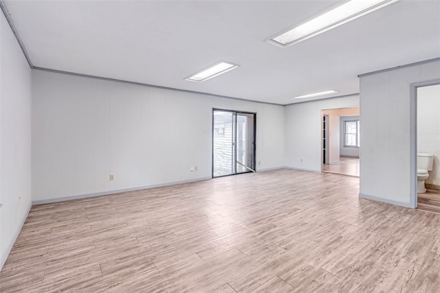 unfurnished room with light wood-type flooring