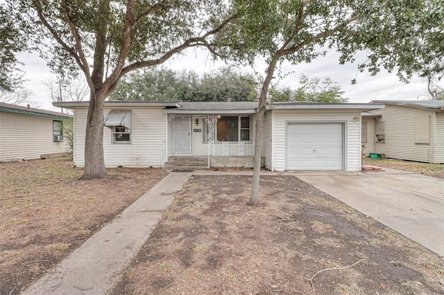 ranch-style home featuring covered porch and a garage