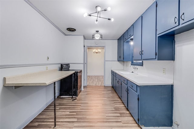 kitchen with sink, a notable chandelier, black electric range, light hardwood / wood-style flooring, and blue cabinets