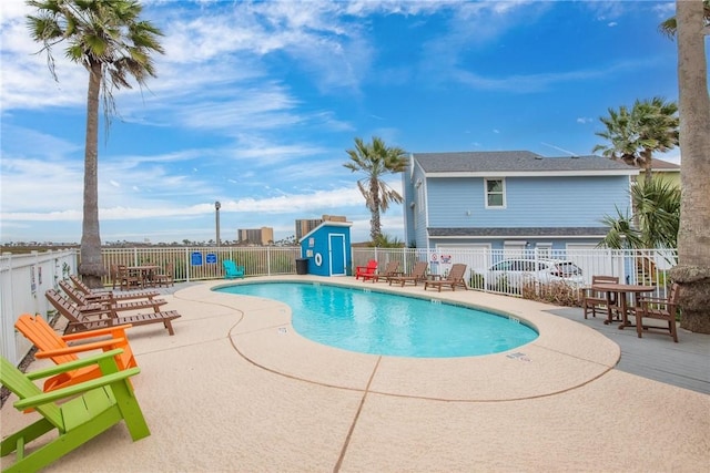 pool featuring a patio area and fence