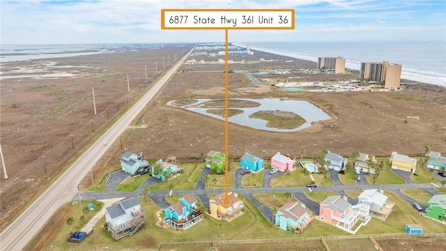 drone / aerial view featuring a view of the beach and a water view