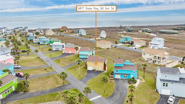 birds eye view of property with a water view and a residential view