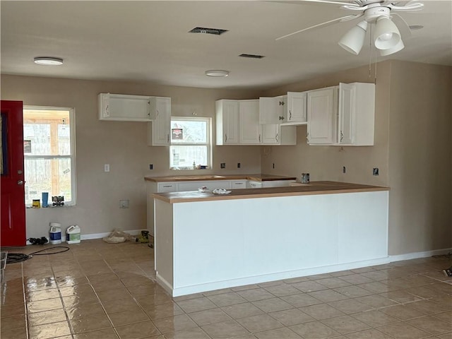 kitchen featuring white cabinetry, plenty of natural light, light tile patterned flooring, and ceiling fan