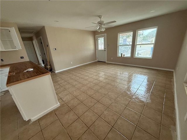 interior space with ceiling fan and light tile patterned flooring