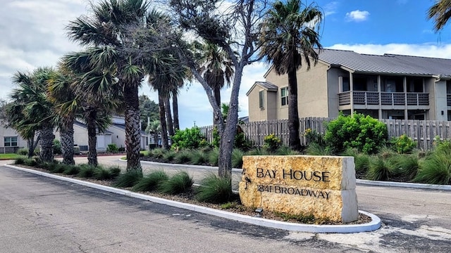 community sign featuring fence