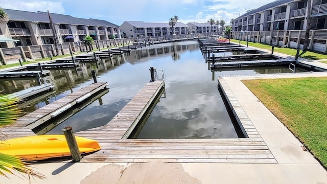 view of dock with a water view and a residential view