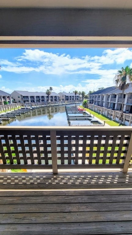 deck with a residential view and a water view