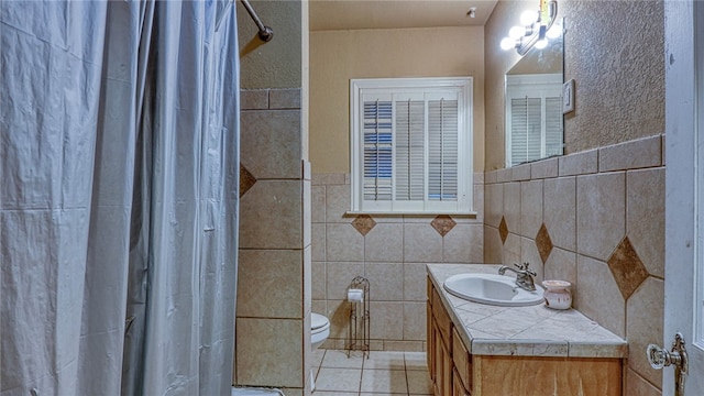 bathroom with tile walls, tile patterned floors, vanity, a shower with shower curtain, and toilet