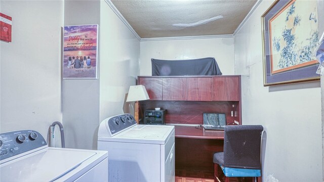 laundry area with a textured ceiling, washer and dryer, and crown molding