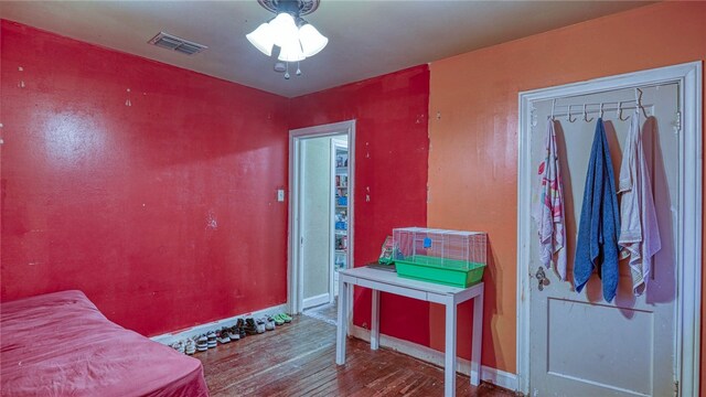 bedroom with wood-type flooring