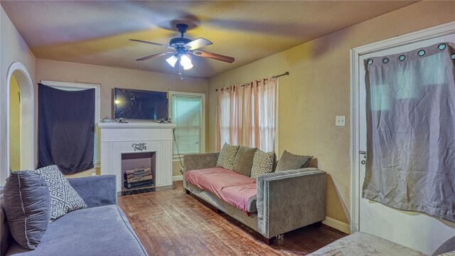 living room featuring wood-type flooring and ceiling fan