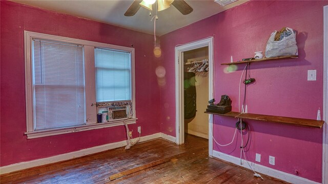 interior space with cooling unit, dark hardwood / wood-style floors, and ceiling fan