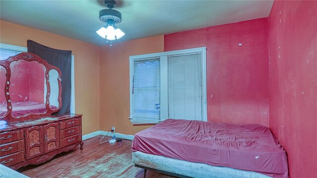 bedroom with wood-type flooring and ceiling fan