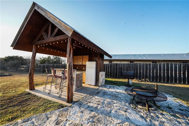 view of patio / terrace featuring a gazebo and exterior bar