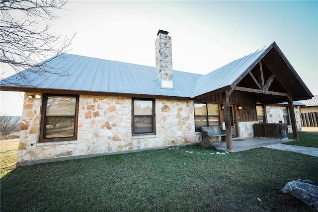 rear view of house featuring a patio and a lawn