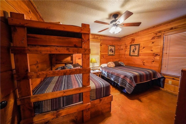 carpeted bedroom featuring ceiling fan and a textured ceiling