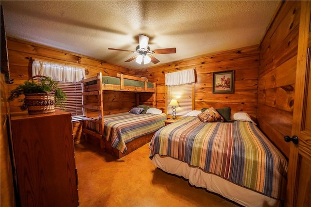 bedroom featuring a textured ceiling, ceiling fan, carpet, and wood walls