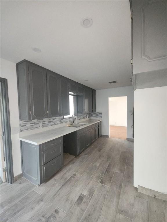 kitchen featuring tasteful backsplash and sink