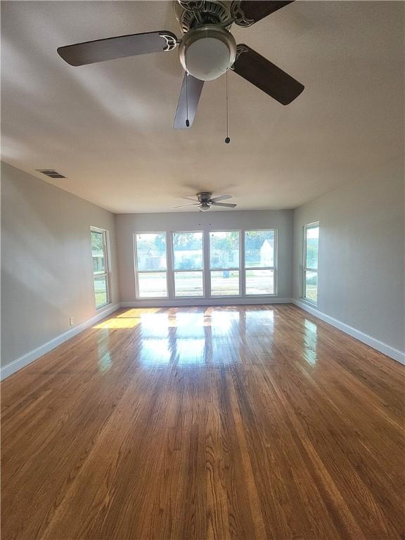 unfurnished room featuring wood-type flooring and a wealth of natural light