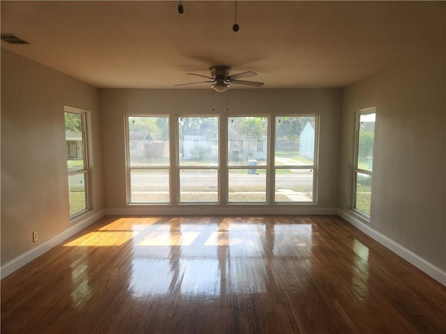 unfurnished sunroom featuring ceiling fan