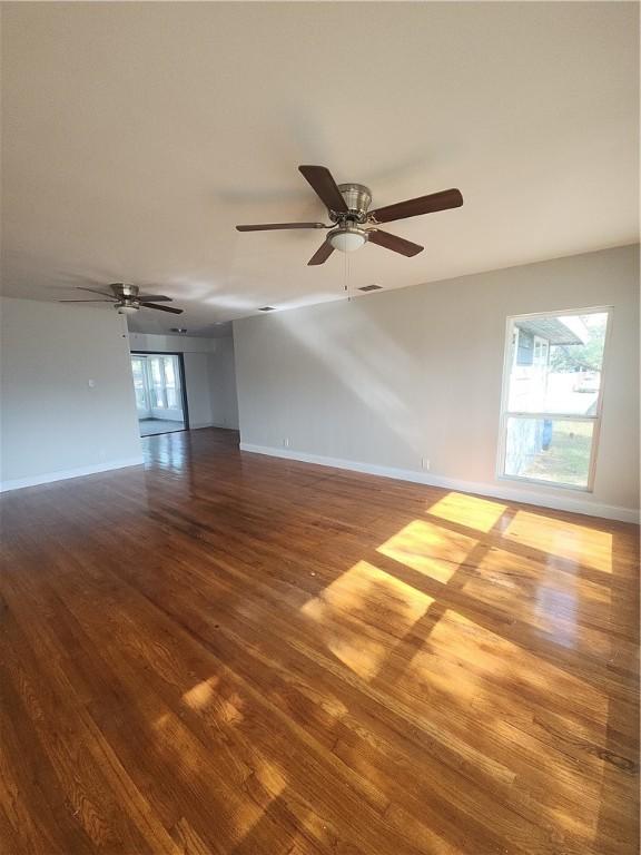 unfurnished room with hardwood / wood-style floors and ceiling fan