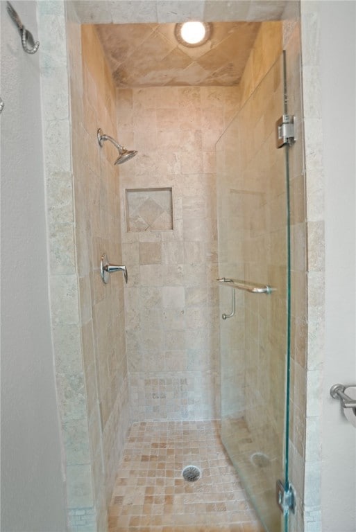 bathroom with a shower with shower door