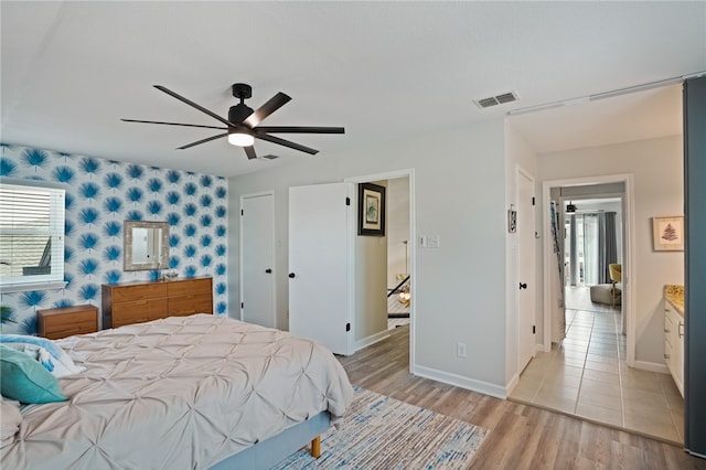 bedroom with light hardwood / wood-style floors and ceiling fan