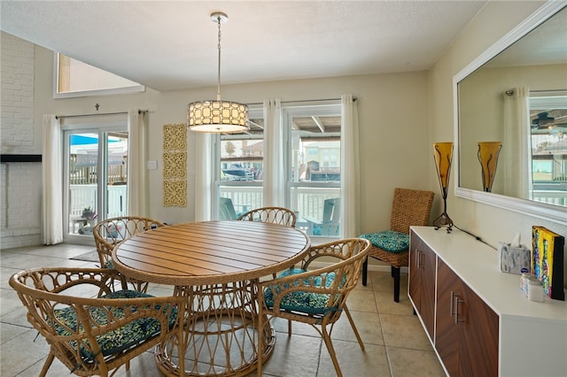 dining space with a textured ceiling and light tile patterned floors