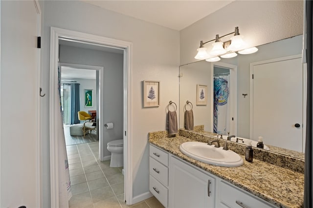 bathroom featuring vanity, tile patterned floors, and toilet