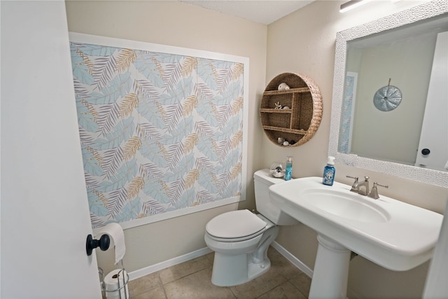 bathroom featuring tile patterned flooring and toilet