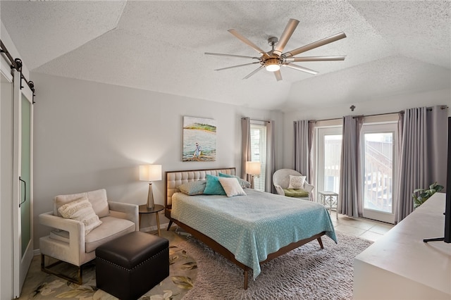 tiled bedroom featuring multiple windows, lofted ceiling, a barn door, and ceiling fan