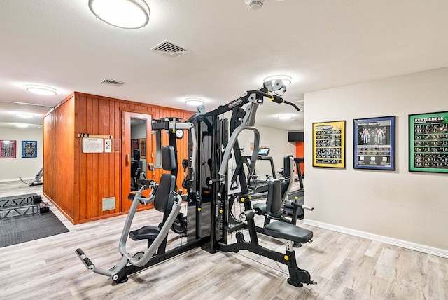 1400 Ocean Dr Unit 904-B, Corpus Christi, TX 78404 - exercise area with light wood-style flooring and wooden walls