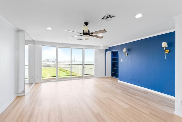 1400 Ocean Dr Unit 904-B, Corpus Christi, TX 78404 - unfurnished room with ceiling fan, crown molding, light wood-style flooring, recessed lighting, and arched walkways