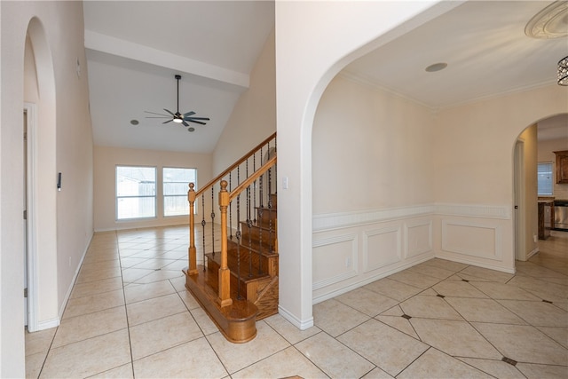 hallway with high vaulted ceiling and light tile patterned floors