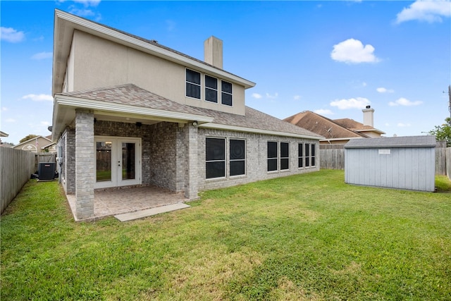 rear view of property featuring a storage unit, central air condition unit, a yard, and a patio