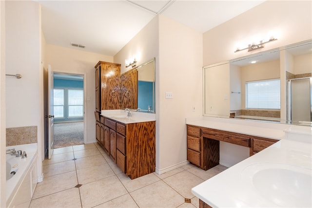 bathroom with plus walk in shower, vanity, and tile patterned flooring