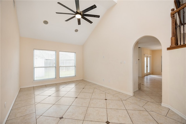 tiled spare room featuring high vaulted ceiling and ceiling fan