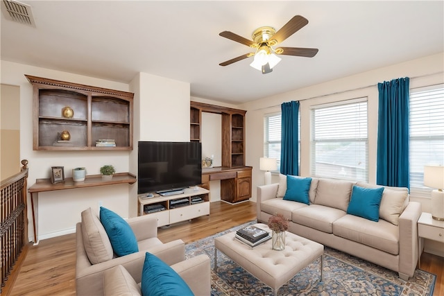 living room with ceiling fan and light hardwood / wood-style flooring