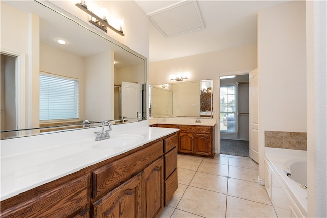 bathroom featuring a bathtub, vanity, and tile patterned flooring