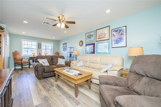 living room with ceiling fan and light wood-type flooring