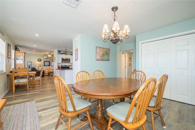 dining area featuring a notable chandelier and light hardwood / wood-style flooring