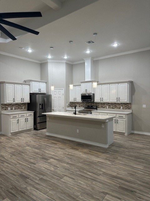 kitchen with white cabinets, dark hardwood / wood-style flooring, hanging light fixtures, and appliances with stainless steel finishes