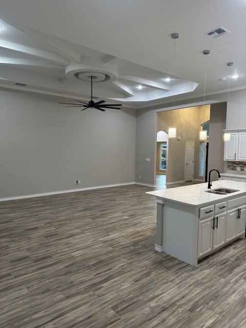 kitchen with ceiling fan, sink, dark wood-type flooring, decorative light fixtures, and white cabinets