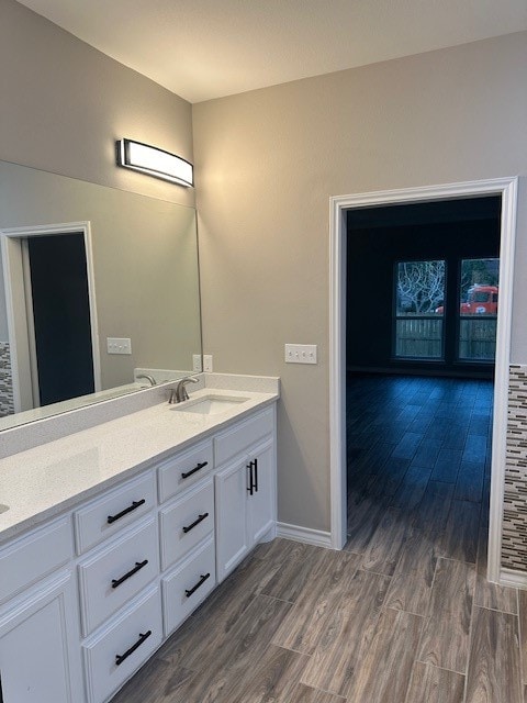 bathroom with hardwood / wood-style floors and vanity