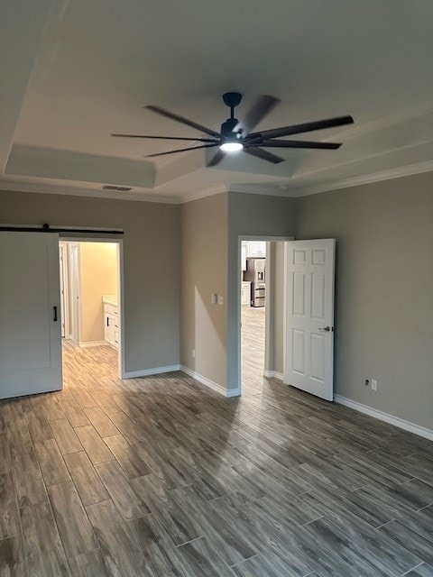 unfurnished room featuring dark hardwood / wood-style floors, ceiling fan, and ornamental molding