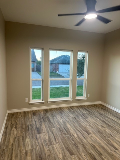 empty room featuring ceiling fan and dark hardwood / wood-style floors